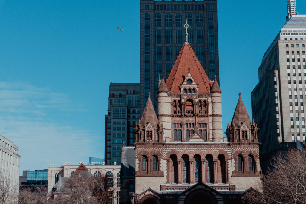 Trinity Church surronded by hotels and office buildings is a great view for your Boston solo trip. 