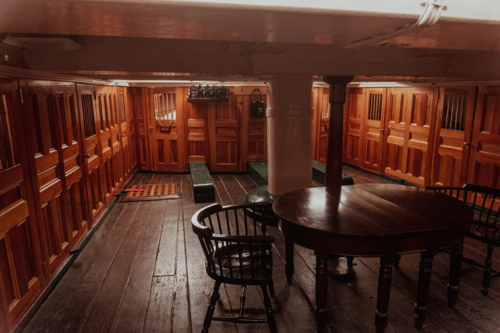 Below the deck of the USS Constitution sits tables and chairs. It is a fun place to tour for your Boston solo trip. 