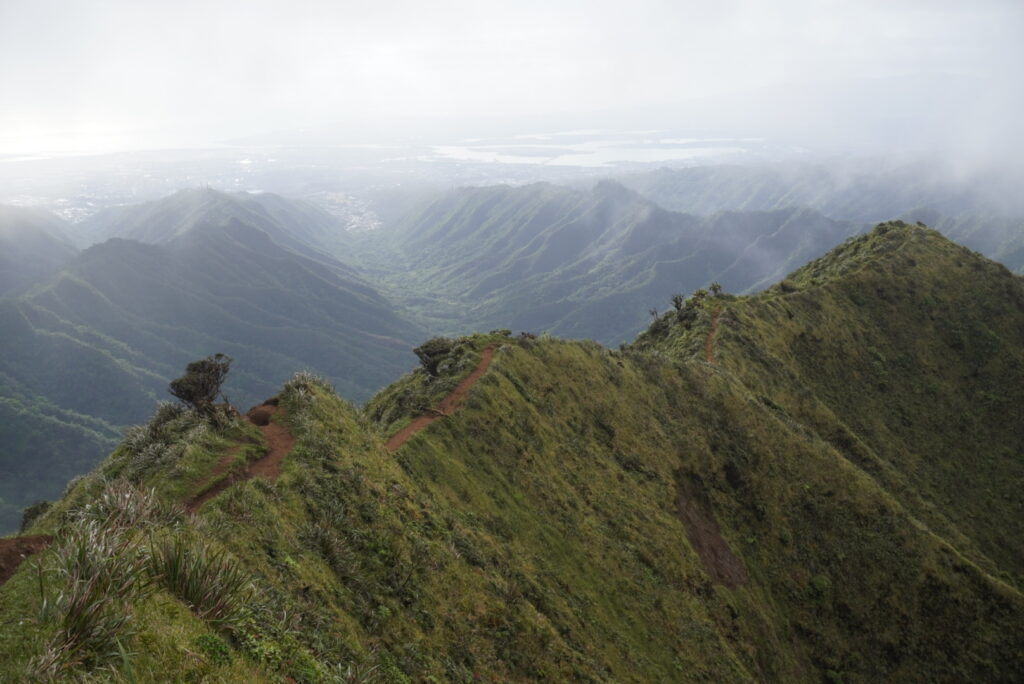 On a mountain ridge on the Hawaiian Island of Oahu, clouds form and rain approaches. 