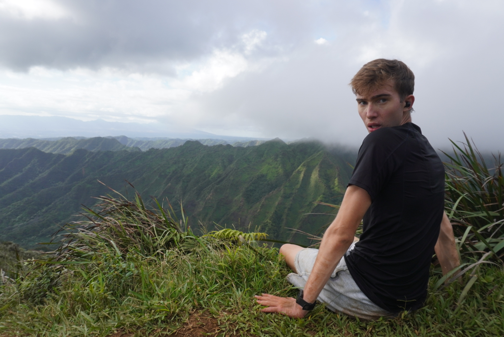 On top of a mountain on Oahu, noah is happy he chose to do this Oahu solo hike.