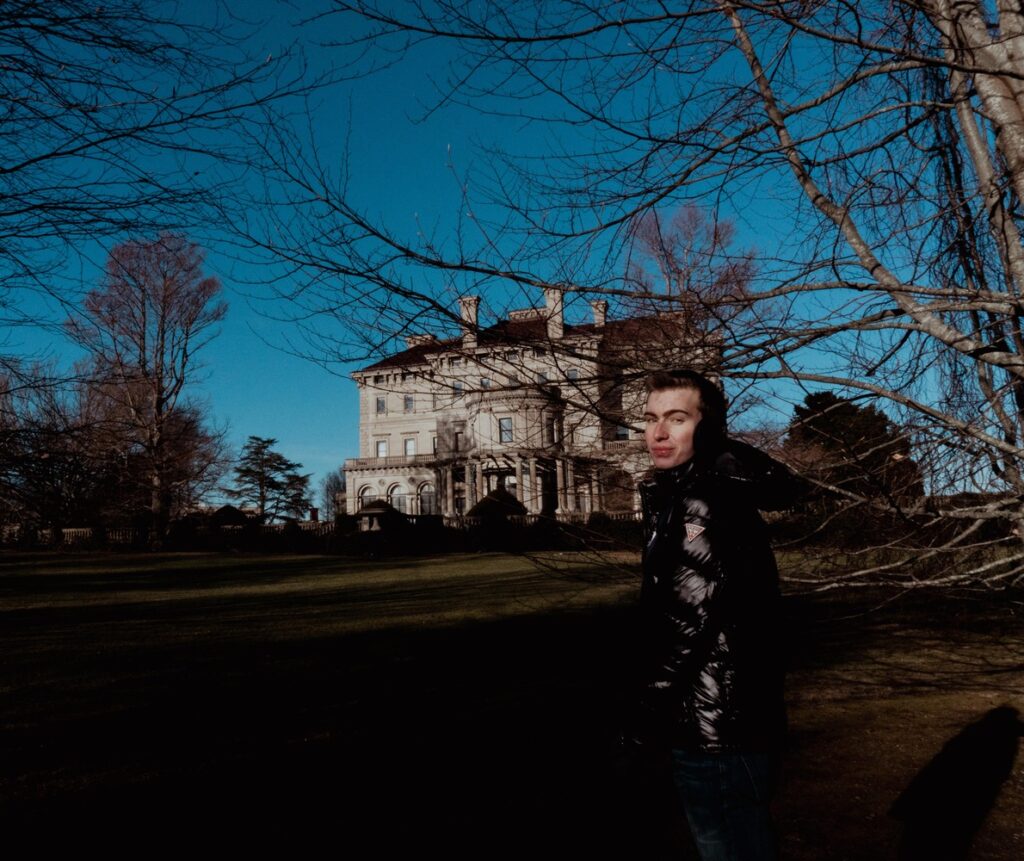 Noah takes the world poses infront of the Breakers Mansion during a solo trip.