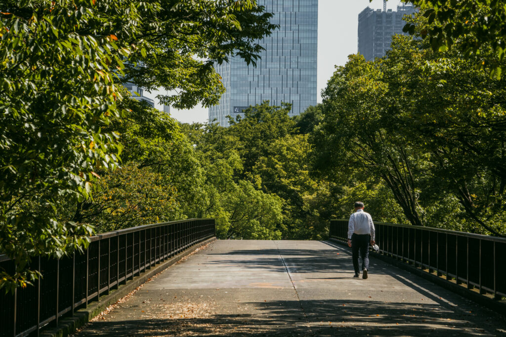 A man walks alone in Yoyogi Park. 