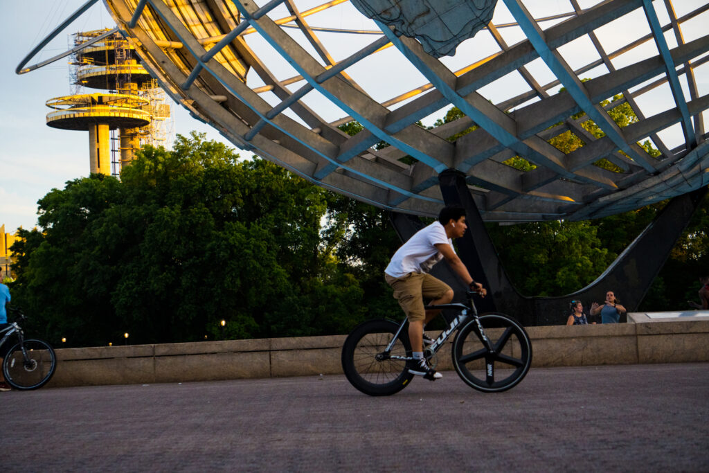 A man rides his bikes through Fleshing Meadows Park in Queens. 