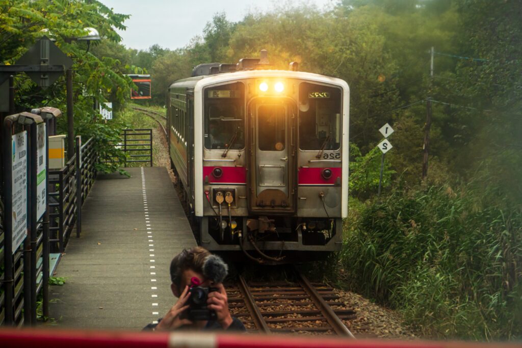 Noah takes a picture of a train approaching the station in Japan. 