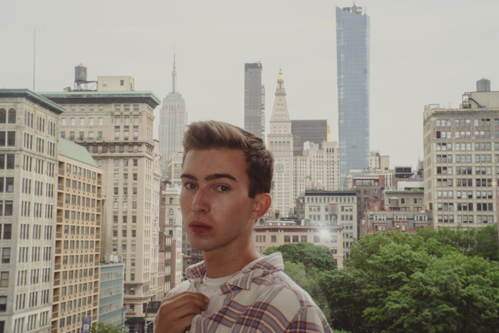 Noah poses for a photo infront of the Empire State Building