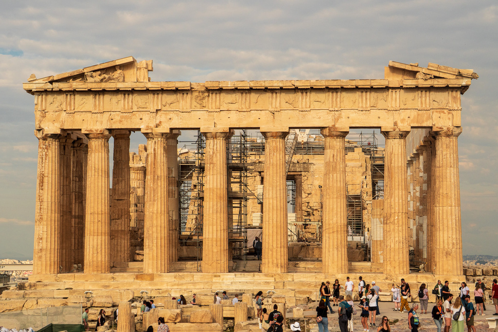 People stand infront of the Acropolis in Athens, Greece. 