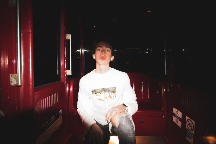 Noah takes a photo of himself in the HEP FIVE Ferris Wheel during his Osaka solo trip