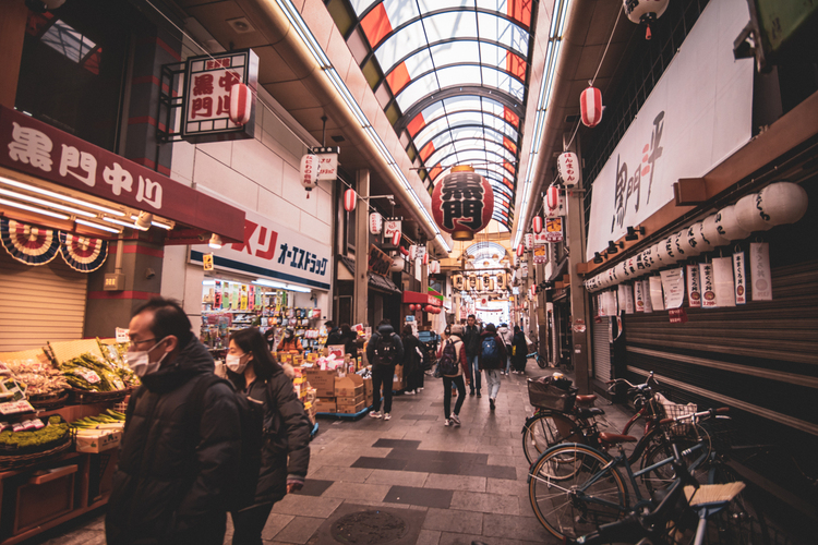 People shop at the Kuromon Market in Osaka