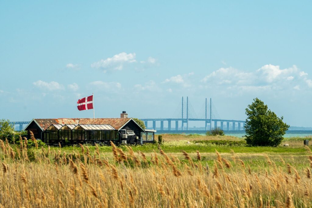 A Danish flag waves infront of the Oresound Bridge.
